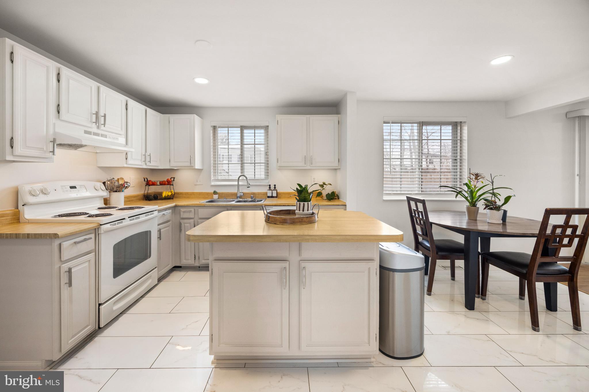 1811 Rustic Hill Court Frederick, MD 21702 - Photo 5 of 48 a kitchen with a stove a sink a table and chairs