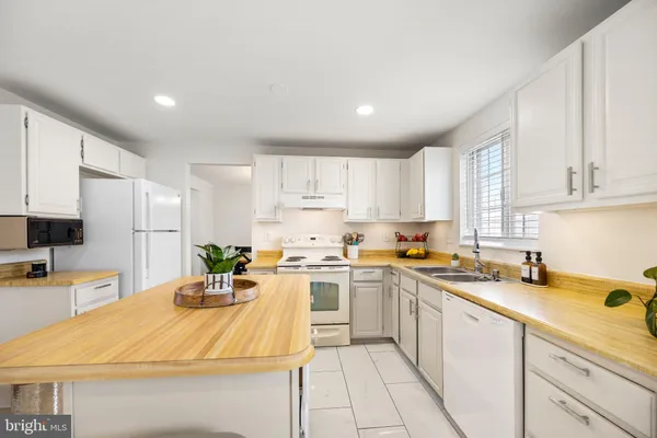 a kitchen with a sink a stove and cabinets
