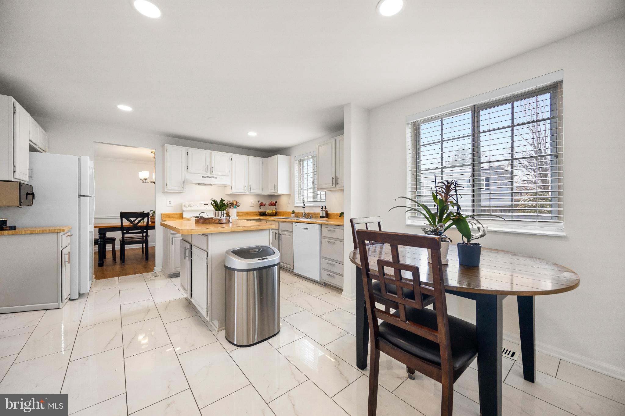 1811 Rustic Hill Court Frederick, MD 21702 - Photo 7 of 48 a kitchen with a dining table chairs and refrigerator