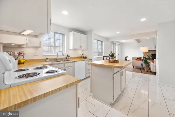 a kitchen with stainless steel appliances granite countertop a sink cabinets and a counter top space
