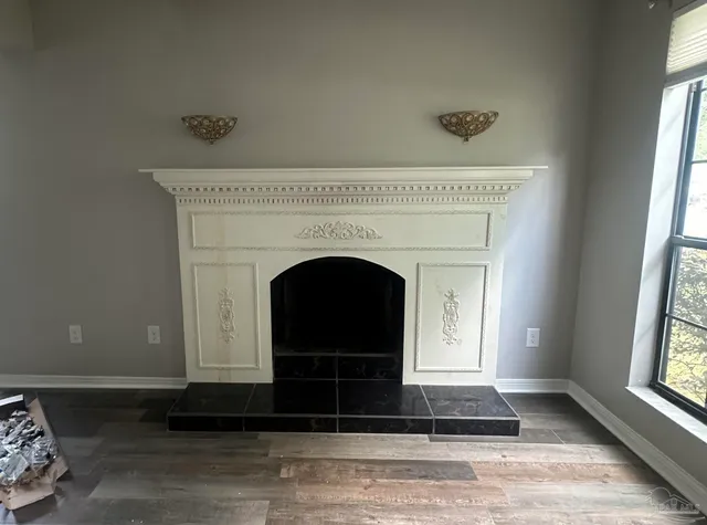 a living room with a fireplace and a window