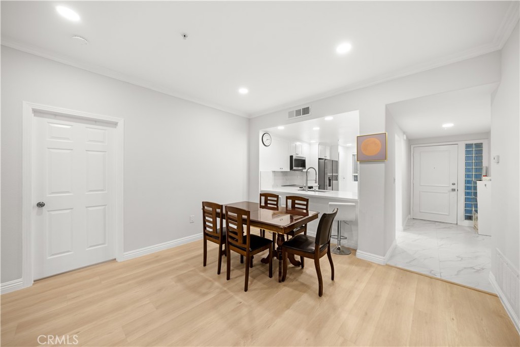 2253 Martin, Unit 106 Irvine, CA 92612 - Photo 11 of 19 a view of a dining room with furniture and wooden floor