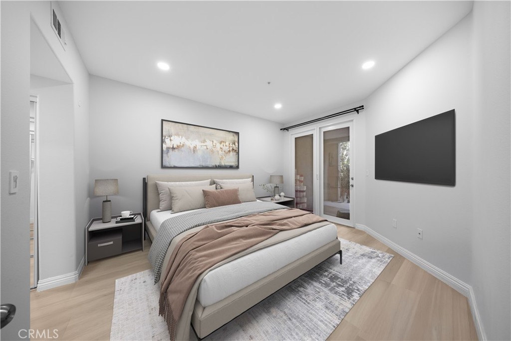 2253 Martin, Unit 106 Irvine, CA 92612 - Photo 3 of 19 a bedroom with a large bed and a flat screen tv