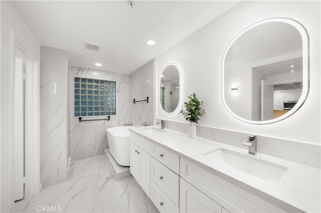 2253 Martin, Unit 106 Irvine, CA 92612 - Photo 4 of 19 a spacious bathroom with a double vanity sink mirror and bathtub