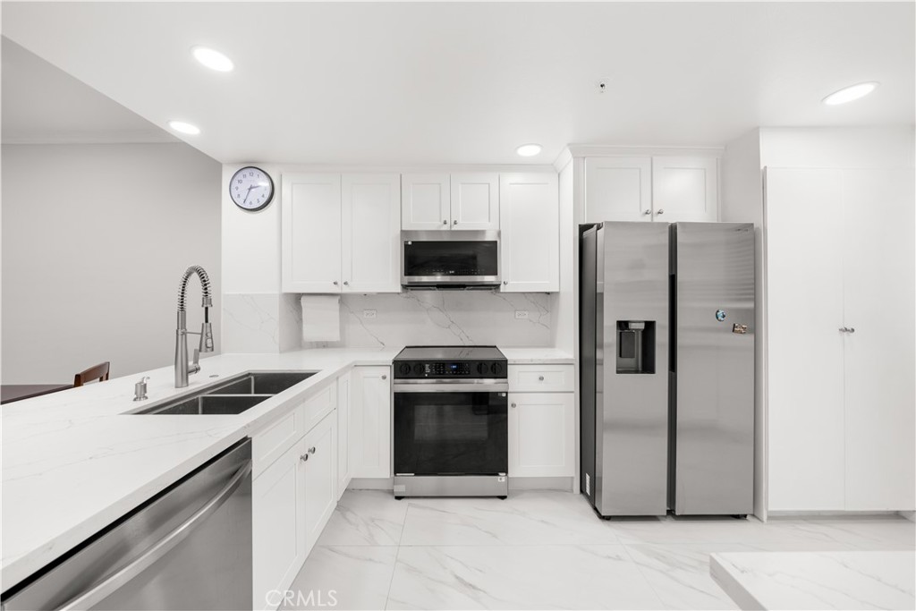 2253 Martin, Unit 106 Irvine, CA 92612 - Photo 7 of 19 a kitchen with a sink cabinets and stainless steel appliances