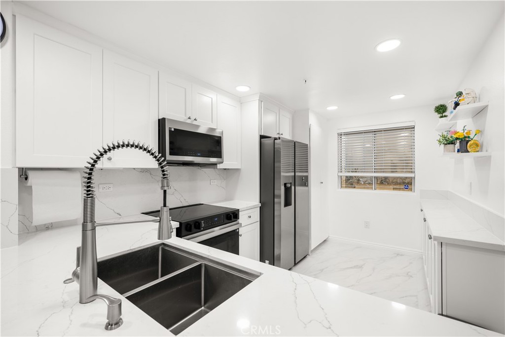 2253 Martin, Unit 106 Irvine, CA 92612 - Photo 8 of 19 a kitchen with stainless steel appliances a refrigerator and microwave
