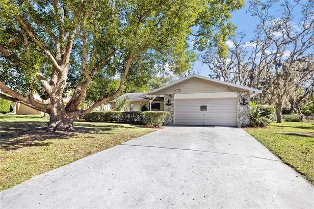 a front view of house with yard and trees