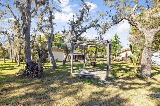 a view of outdoor space with garden and trees