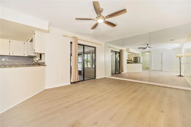 a view of a kitchen with a sink and a refrigerator