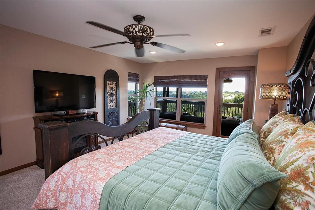 7060 Hells Gate Loop Strawn, TX 76475 - Photo 12 of 40 Bedroom featuring access to exterior, carpet floors, recessed lighting, and ceiling fan