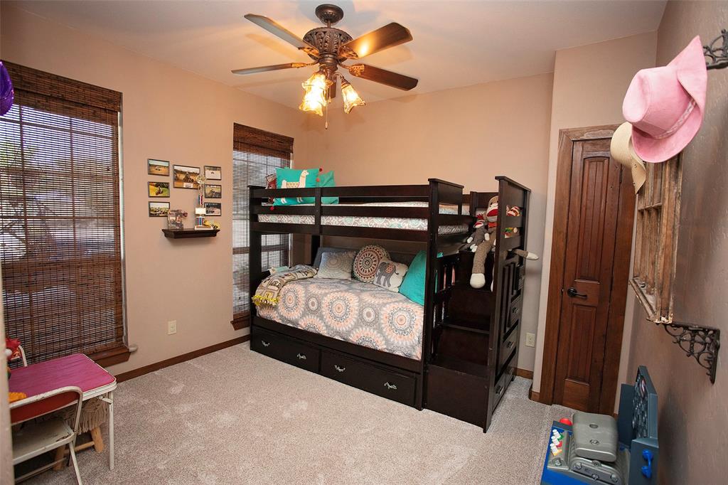 7060 Hells Gate Loop Strawn, TX 76475 - Photo 17 of 40 Carpeted bedroom with baseboards and a ceiling fan