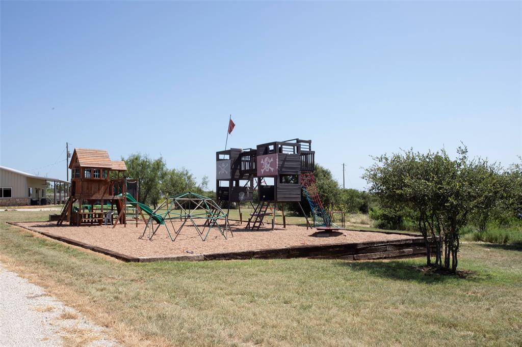 7060 Hells Gate Loop Strawn, TX 76475 - Photo 25 of 40 Private playground featuring a yard