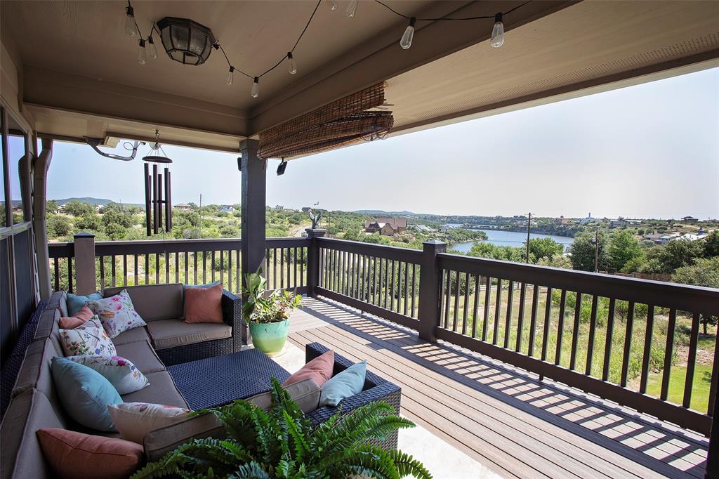 7060 Hells Gate Loop Strawn, TX 76475 - Photo 3 of 40 Wooden terrace featuring an outdoor hangout area and a water view