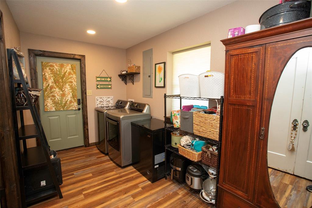 7060 Hells Gate Loop Strawn, TX 76475 - Photo 39 of 40 Laundry room featuring washer and dryer, wood finished floors, recessed lighting, and electric panel