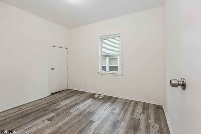 112 Pompton Avenue, Unit 1 Verona, NJ 07044 - Photo 12 of 25 a view of a room with wooden floor and window
