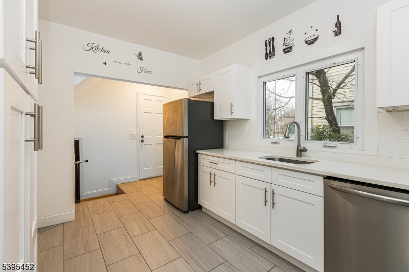 112 Pompton Avenue, Unit 1 Verona, NJ 07044 - Photo 15 of 25 a kitchen with a refrigerator and a sink