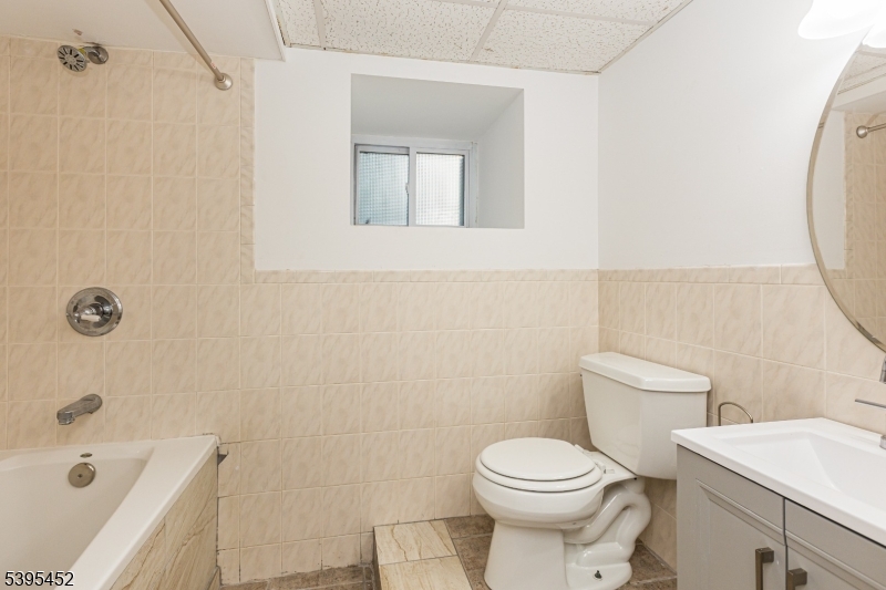 112 Pompton Avenue, Unit 1 Verona, NJ 07044 - Photo 21 of 25 a white toilet sitting next to a bathroom sink