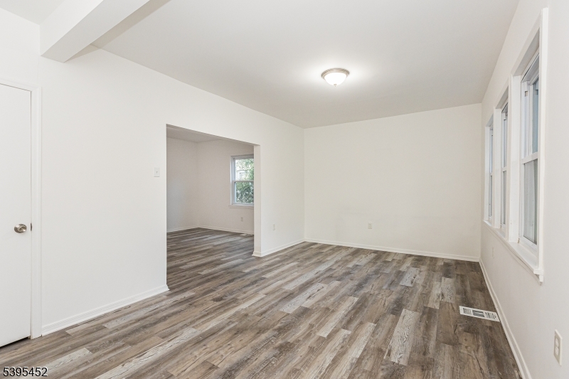112 Pompton Avenue, Unit 1 Verona, NJ 07044 - Photo 4 of 25 wooden floor in an empty room with a window