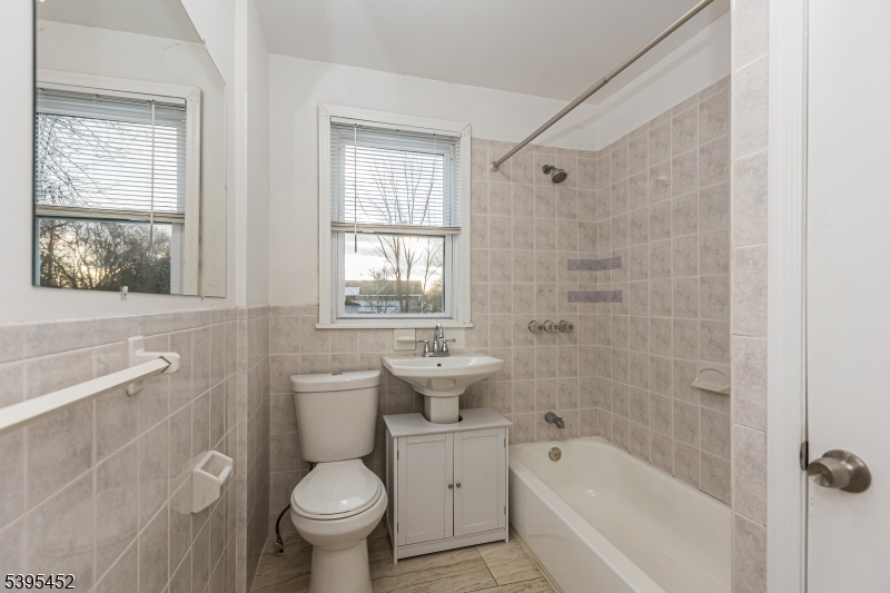 112 Pompton Avenue, Unit 1 Verona, NJ 07044 - Photo 9 of 25 a bathroom with a toilet sink and bathtub