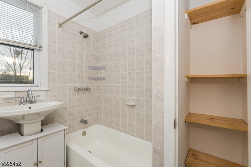 112 Pompton Avenue, Unit 1 Verona, NJ 07044 - Photo 10 of 25 a bathroom with a sink a toilet and shower