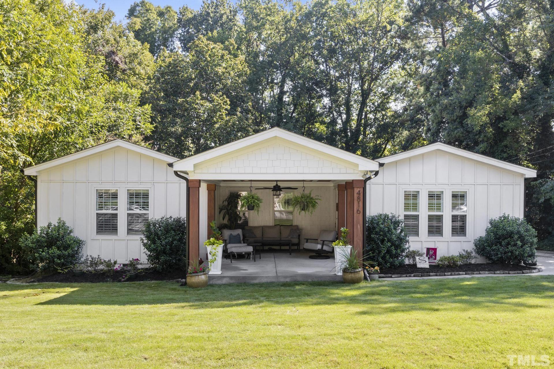 4816 Radcliff Road Raleigh, NC 27609 - Photo 1 of 52 a front view of a house with a garden and swimming pool