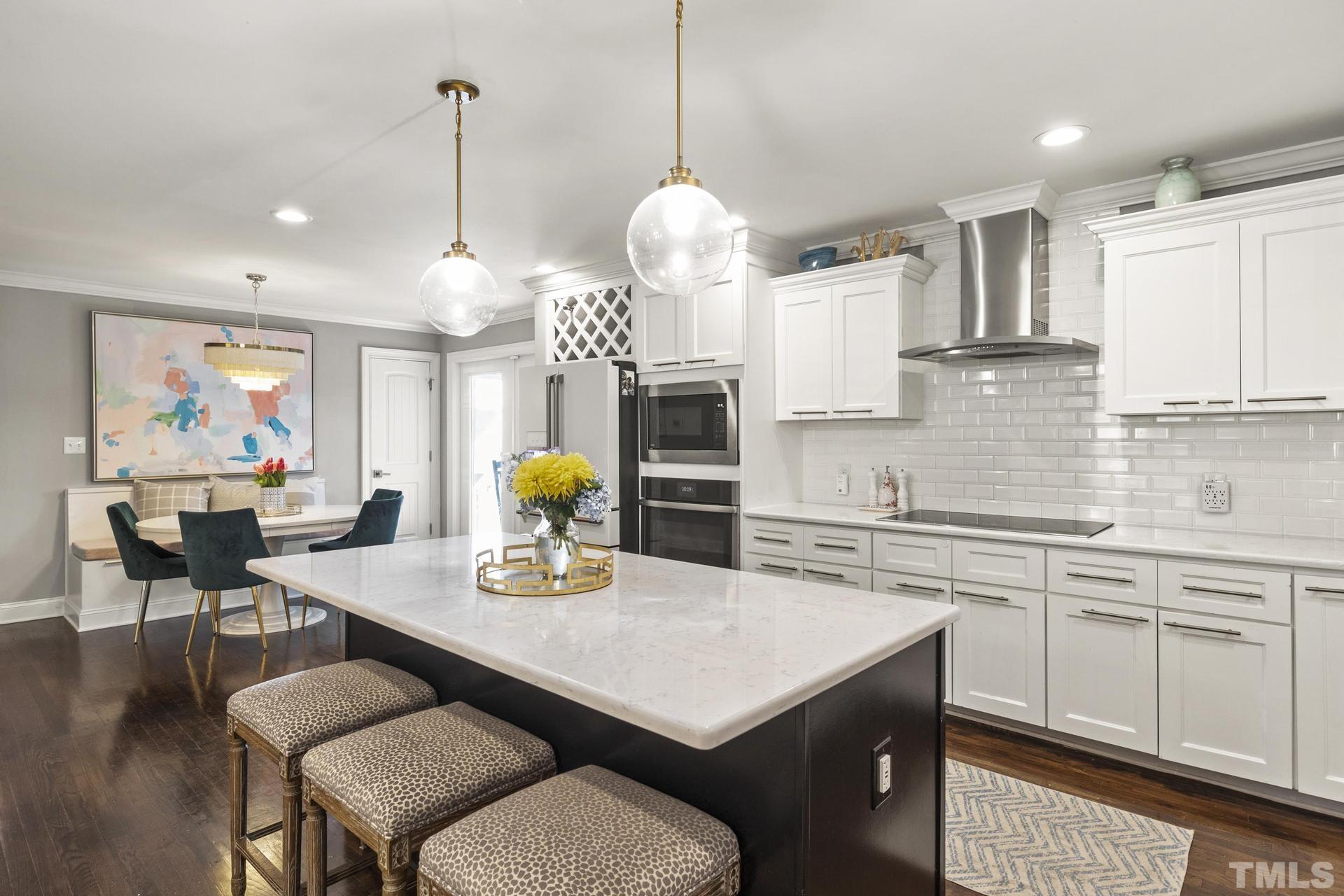 4816 Radcliff Road Raleigh, NC 27609 - Photo 15 of 52 a kitchen with a table chairs sink and cabinets