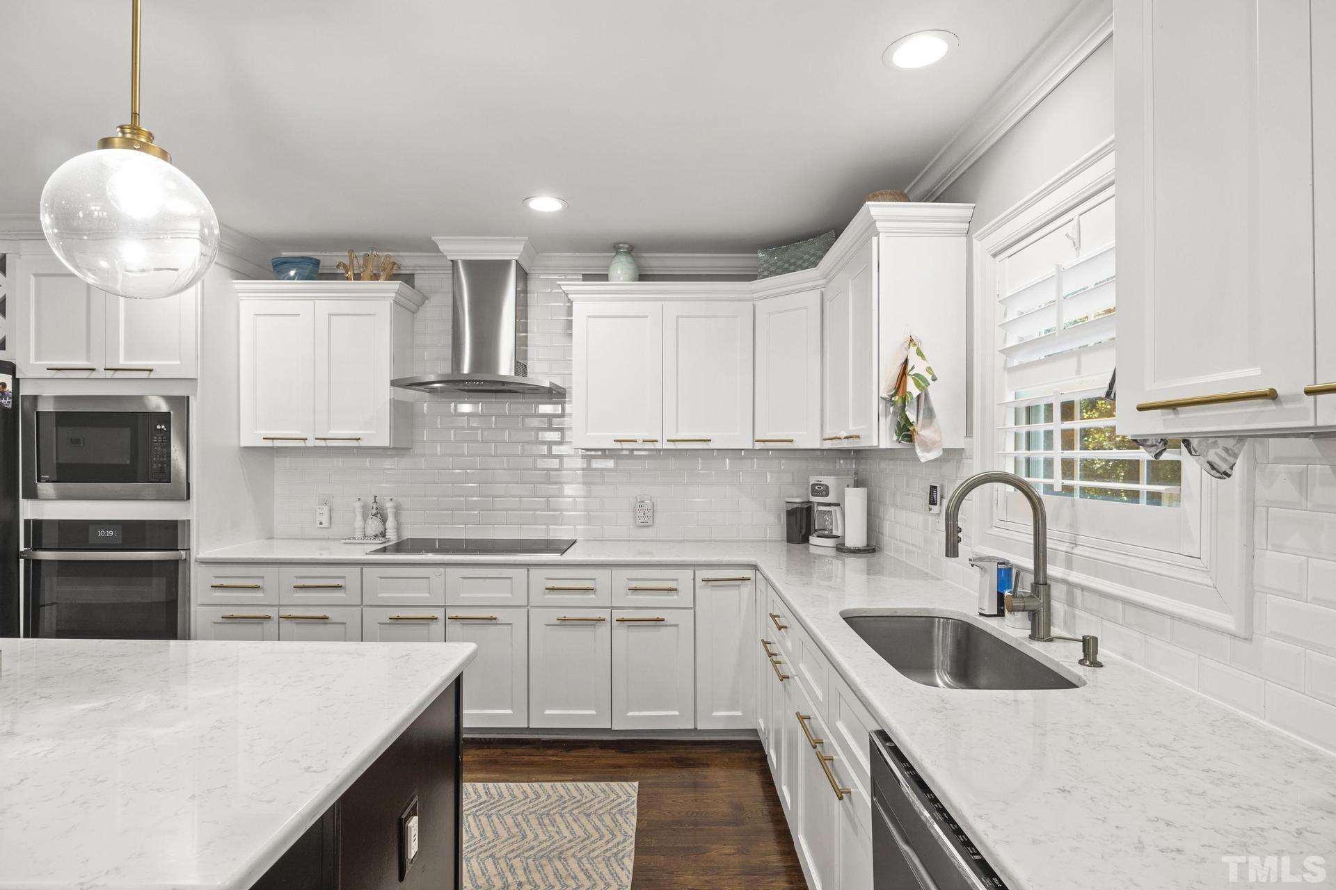 4816 Radcliff Road Raleigh, NC 27609 - Photo 16 of 52 a kitchen with stainless steel appliances granite countertop a sink stove and refrigerator