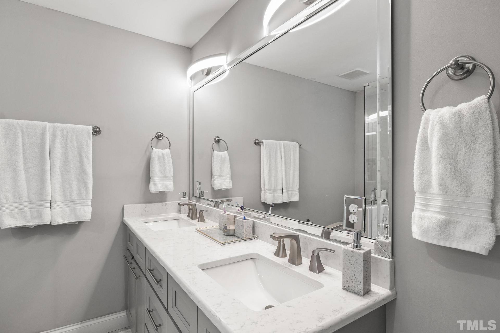 4816 Radcliff Road Raleigh, NC 27609 - Photo 22 of 52 a bathroom with double sink and a mirror