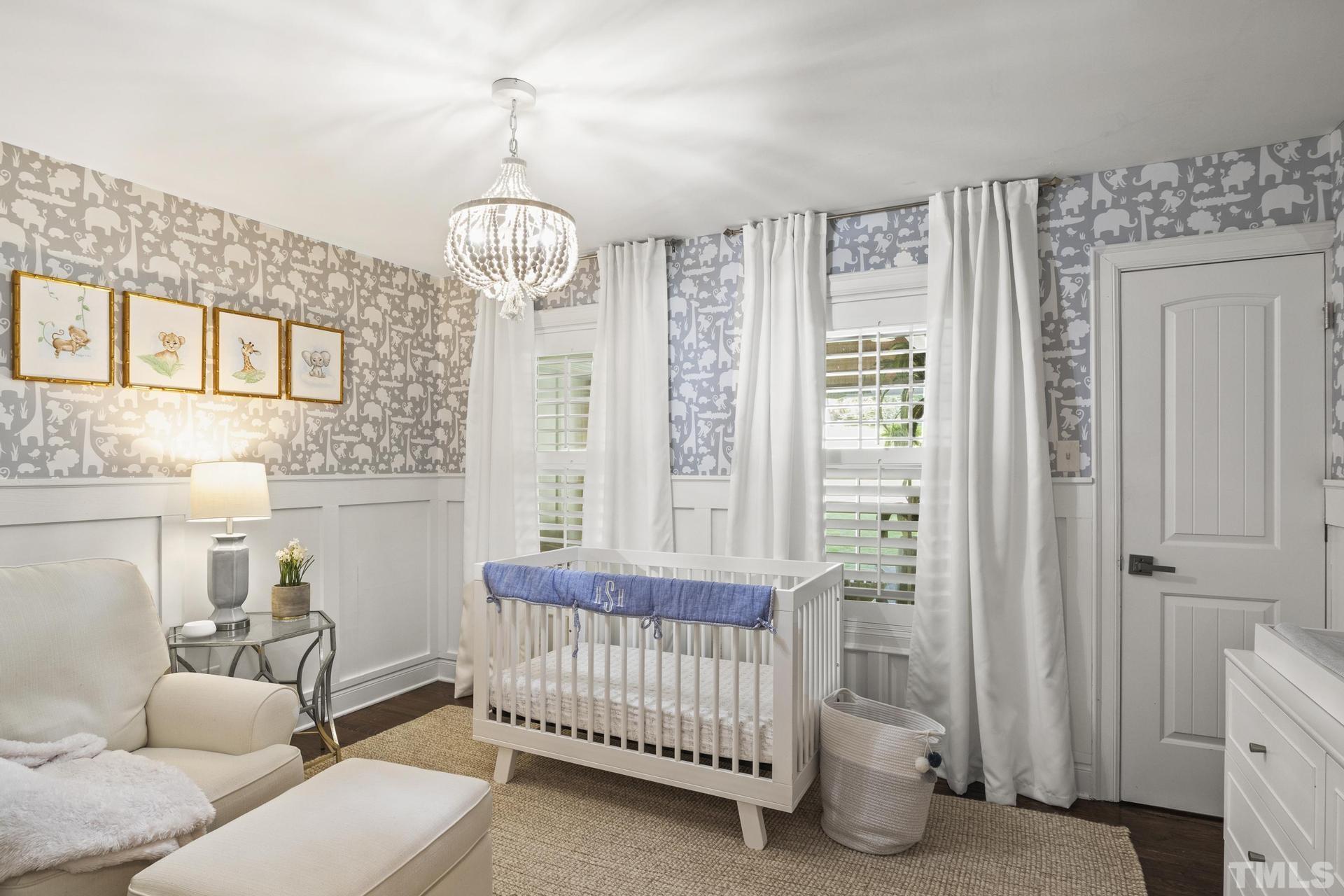 4816 Radcliff Road Raleigh, NC 27609 - Photo 24 of 52 a bedroom with furniture and a chandelier