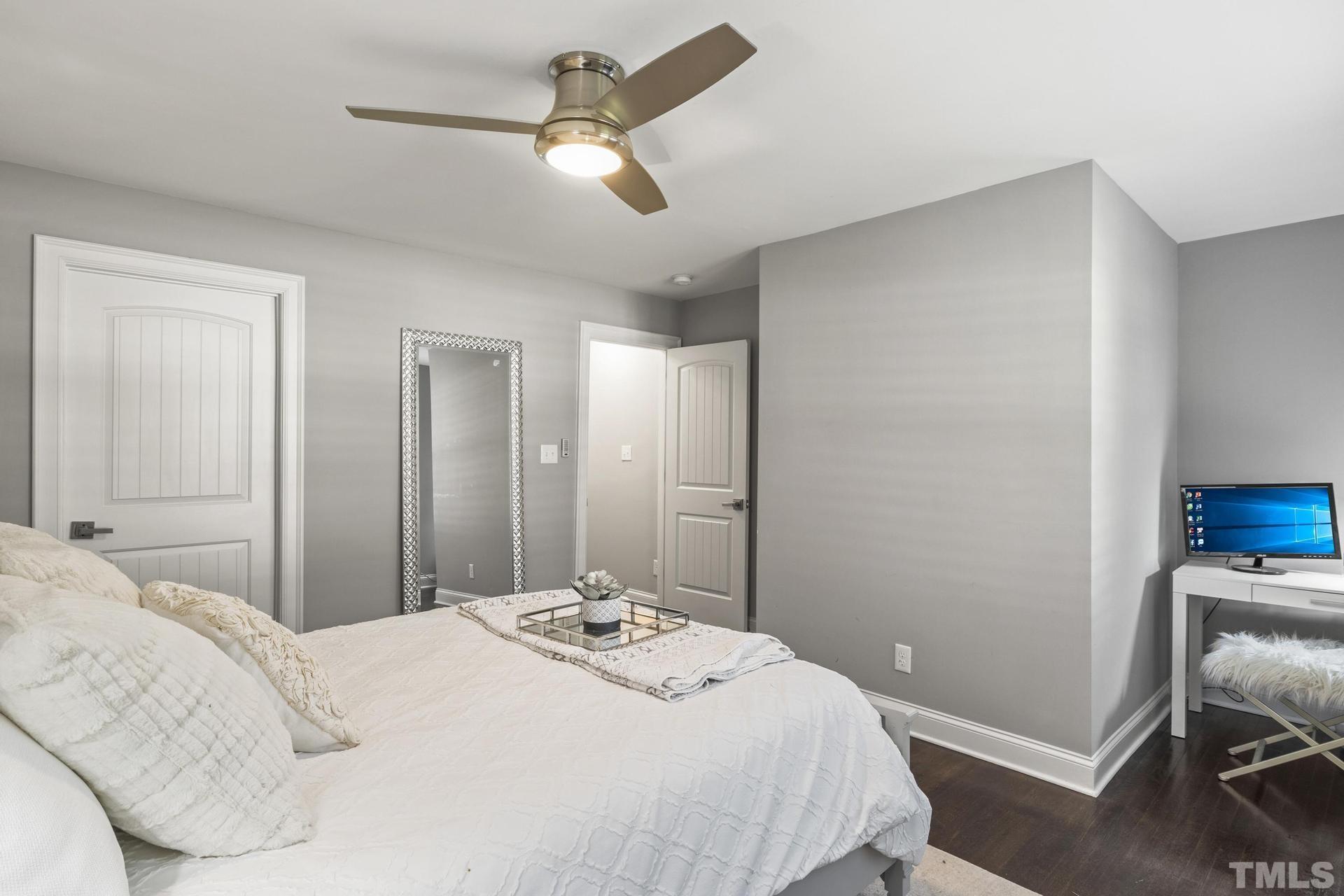 4816 Radcliff Road Raleigh, NC 27609 - Photo 28 of 52 a bedroom with a bed and a chandelier