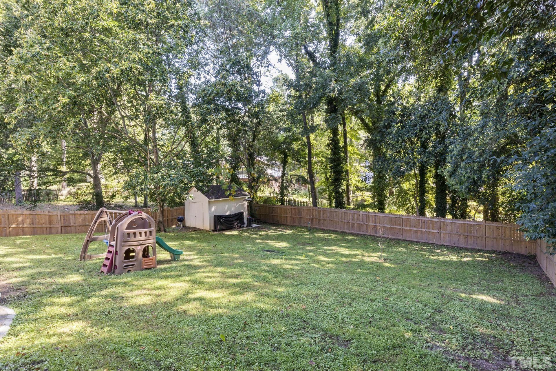 4816 Radcliff Road Raleigh, NC 27609 - Photo 48 of 52 a backyard of a house with table and chairs