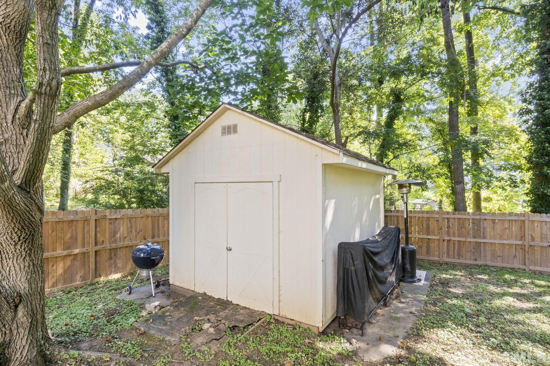 4816 Radcliff Road Raleigh, NC 27609 - Photo 49 of 52 a backyard of a house with large trees and wooden fence