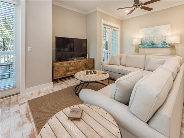 138 East E Pine, Unit A Inlet Beach, FL 32461 - Photo 16 of 48 a living room with furniture a flat screen tv and a large window