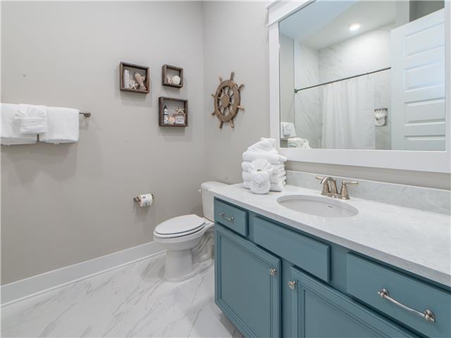 138 East E Pine, Unit A Inlet Beach, FL 32461 - Photo 21 of 48 a bathroom with a granite countertop sink a toilet and a mirror