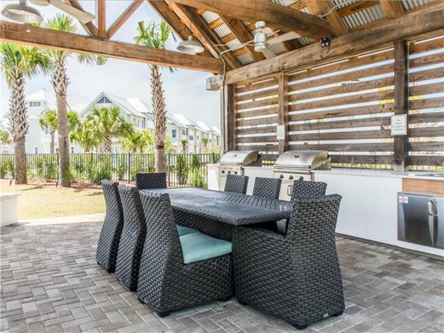 138 East E Pine, Unit A Inlet Beach, FL 32461 - Photo 42 of 48 a dining room with furniture and a floor to ceiling window