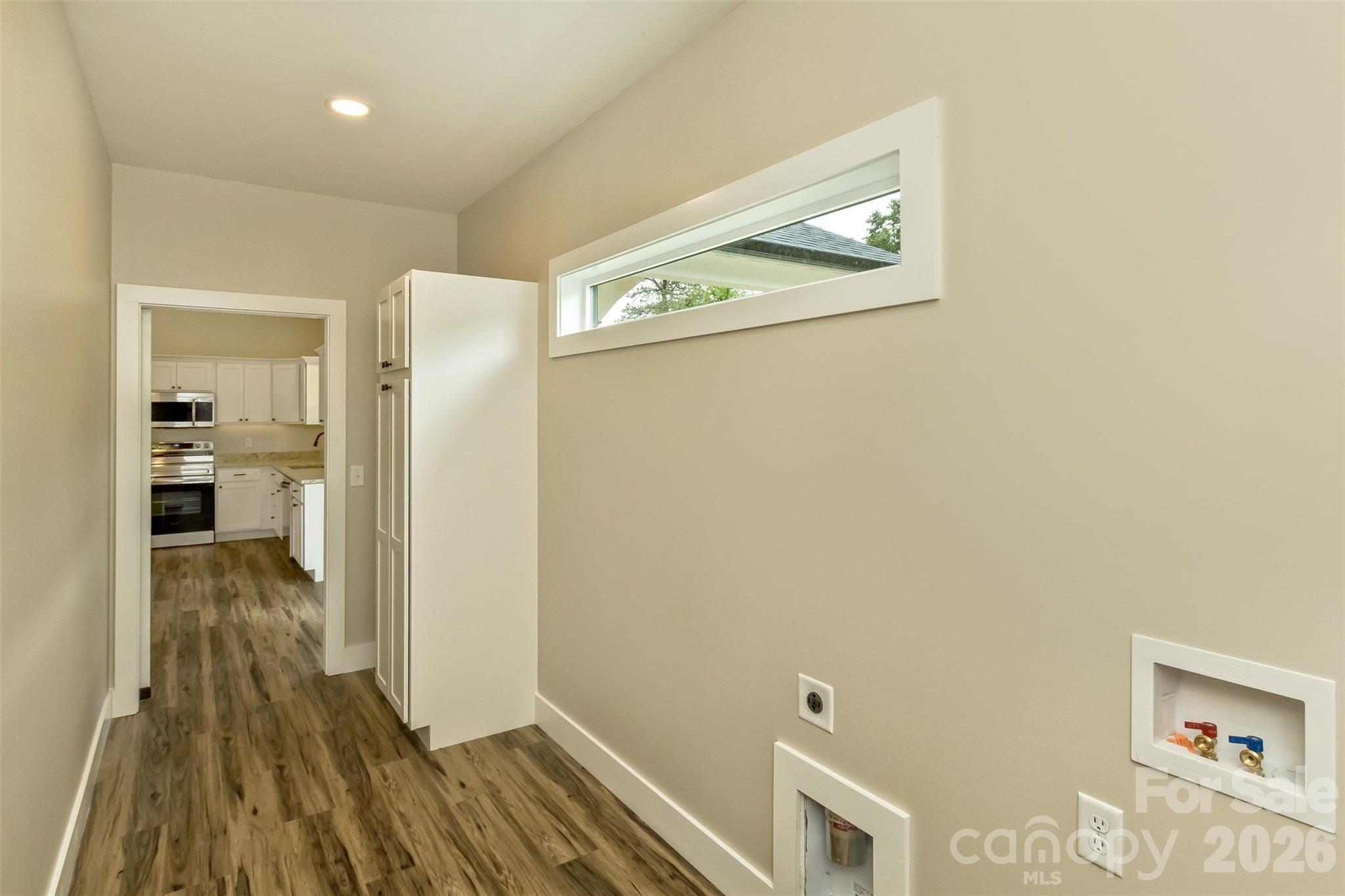112 Peyton Elaine Road Clyde, NC 28721 - Photo 14 of 35 a view of a hallway with wooden floor and a bathroom