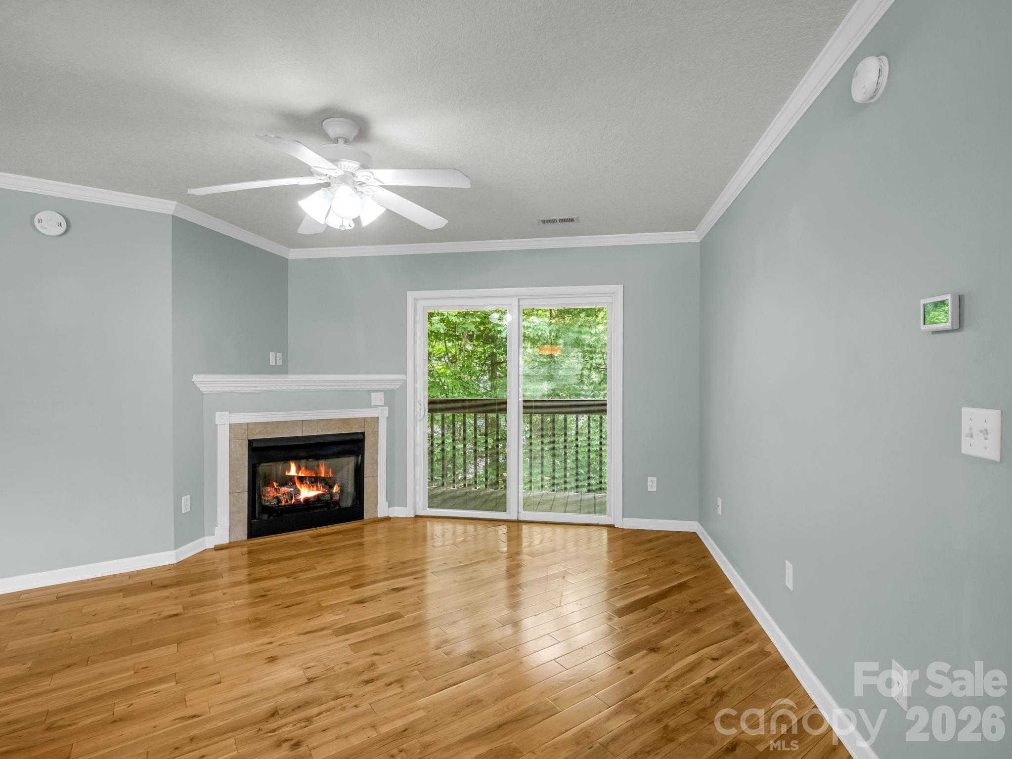 4 Rathfarnham Road, Unit 4F Asheville, NC 28803 - Photo 10 of 33 a view of an empty room with wooden floor fireplace and a window
