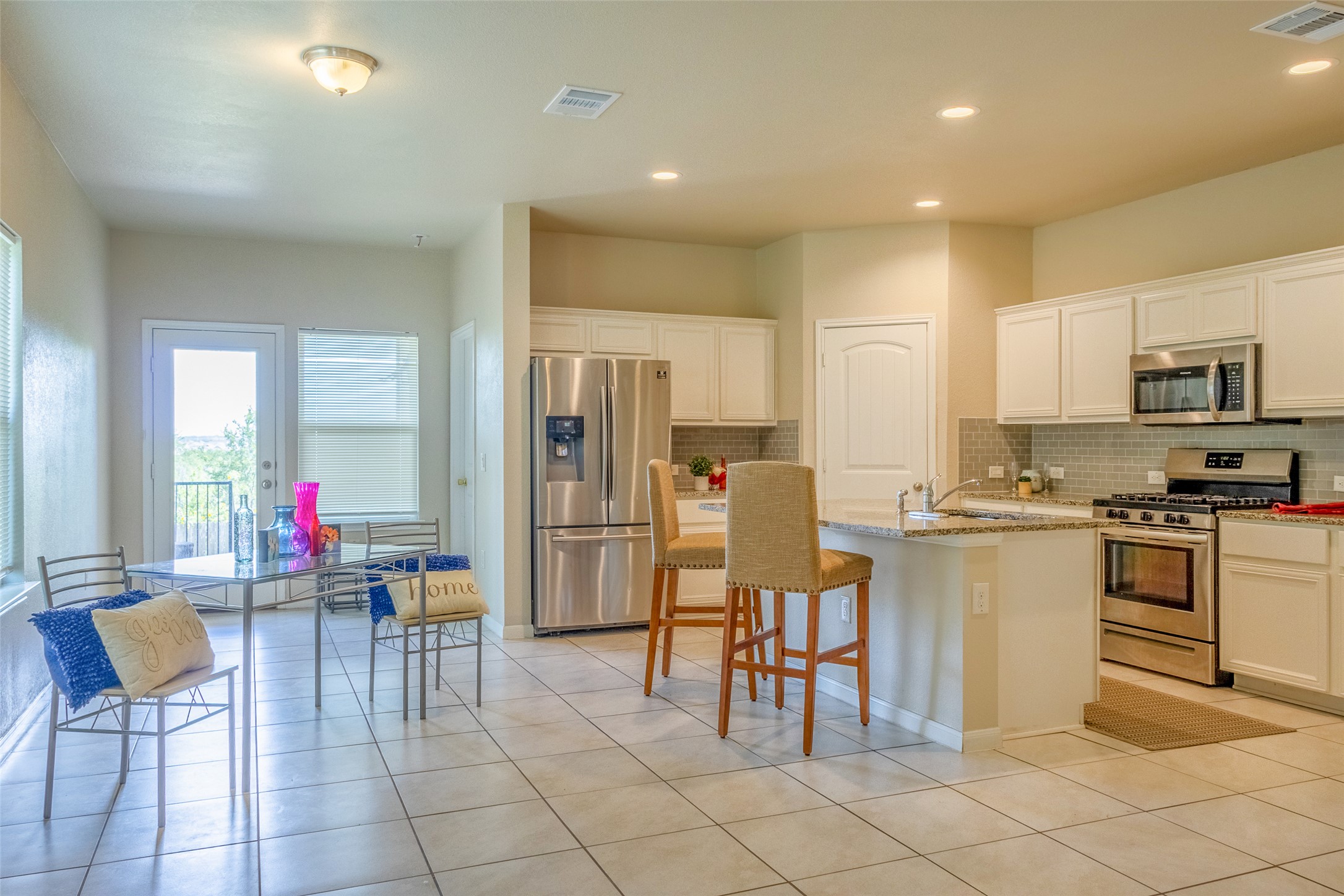 7225 Ranchito Drive Austin, TX 78744 - Photo 7 of 39 A well-appointed kitchen and dining area feature stainless steel appliances and an inviting breakfast bar.