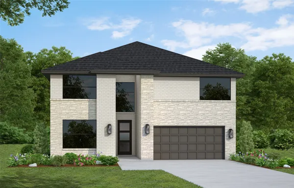 a front view of a house with a garden and yard