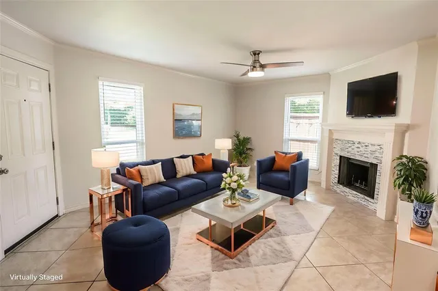 a living room with furniture fireplace and flat screen tv