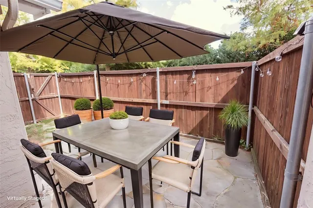 a view of backyard of house with seating space