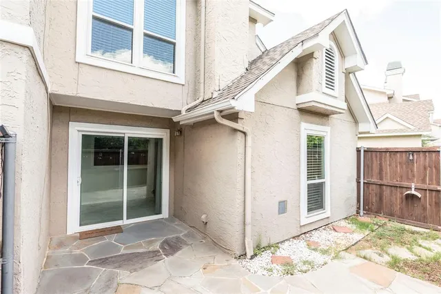 a view of a white house with a large window