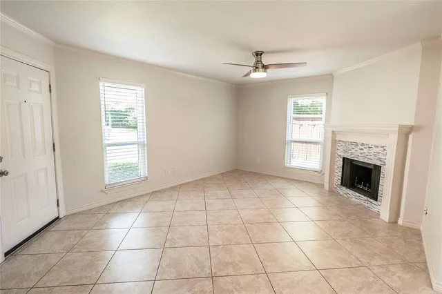 a view of an empty room with a fireplace and a window