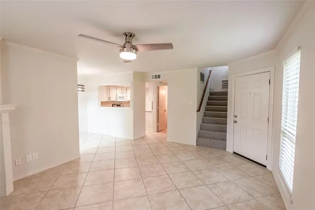 an empty room with closet and windows