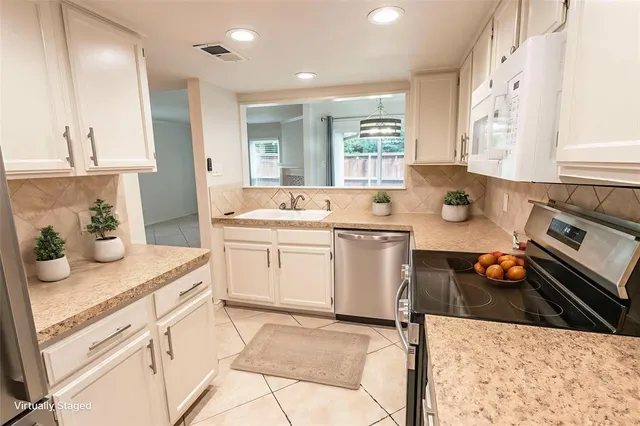 a kitchen with a sink stove and cabinets