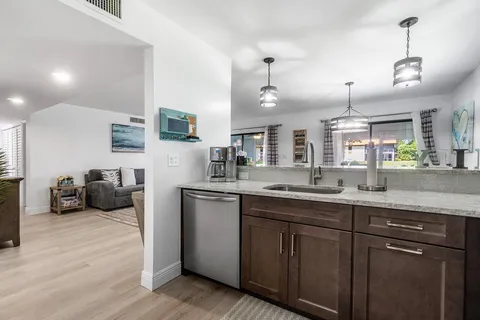 a kitchen with sink and refrigerator