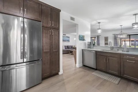 a kitchen with stainless steel appliances a refrigerator and a sink