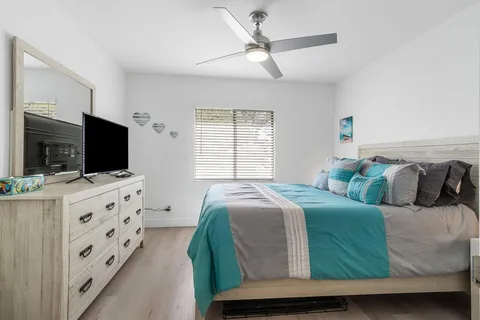 a bedroom with a bed and a flat screen tv