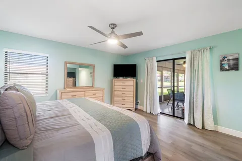 a spacious bedroom with a large bed and a flat screen tv