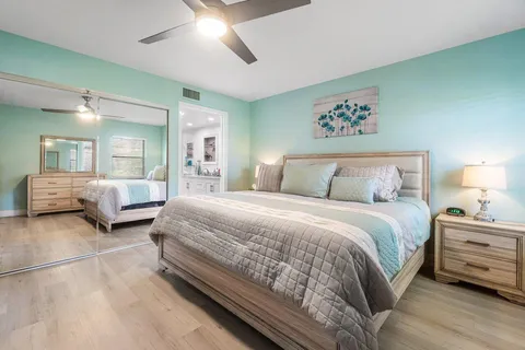 a bedroom with bed and a large mirror